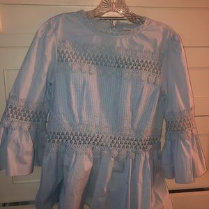 Light blue, lace detailed blouse.